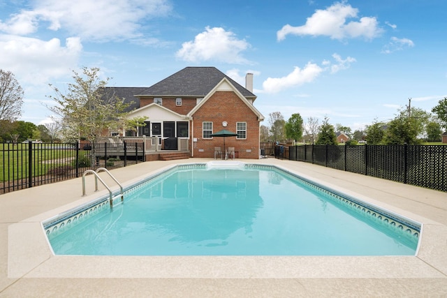view of swimming pool featuring fence, a patio, and a fenced in pool