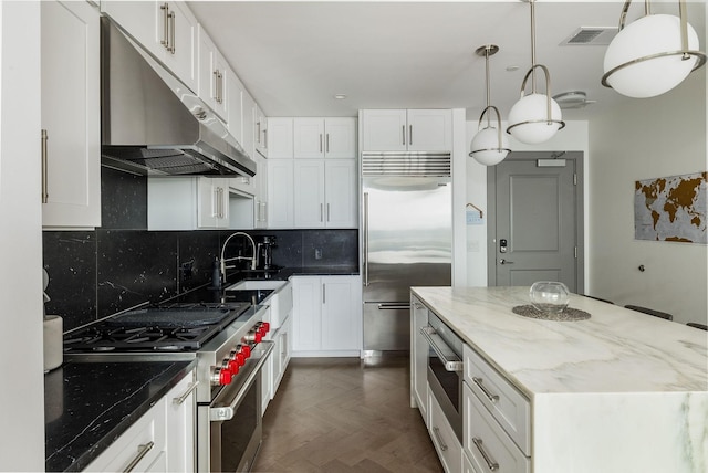 1616 W End Ave Unit 1803, Nashville, TN 37203 - kitchen featuring light stone counters, a sink, high end appliances, under cabinet range hood, and visible vents