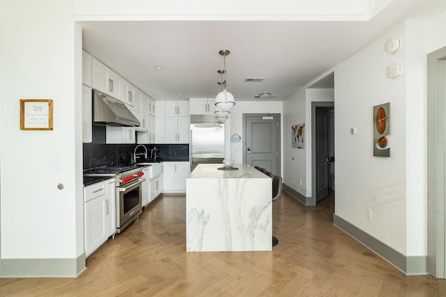 1616 W End Ave Unit 1803, Nashville, TN 37203 - kitchen featuring visible vents, baseboards, premium appliances, white cabinetry, and under cabinet range hood