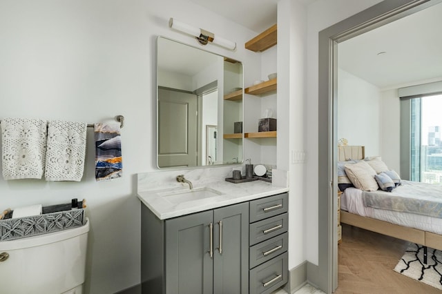 1616 W End Ave Unit 1803, Nashville, TN 37203 - ensuite bathroom with baseboards, vanity, connected bathroom, and toilet