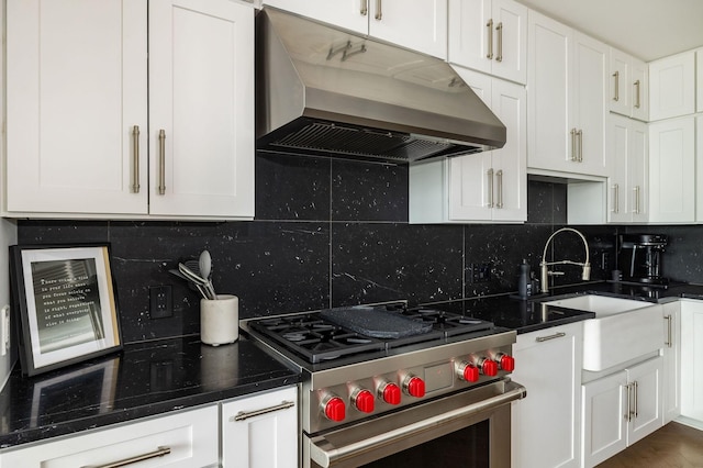 1616 W End Ave Unit 1803, Nashville, TN 37203 - kitchen with high end stainless steel range, dark countertops, under cabinet range hood, and white cabinetry