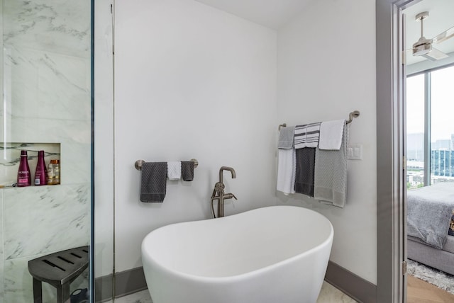 1616 W End Ave Unit 1803, Nashville, TN 37203 - ensuite bathroom featuring baseboards, a freestanding tub, and ensuite bathroom