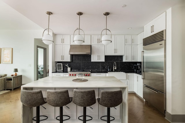 1616 W End Ave Unit 1803, Nashville, TN 37203 - kitchen featuring built in refrigerator, backsplash, under cabinet range hood, and range