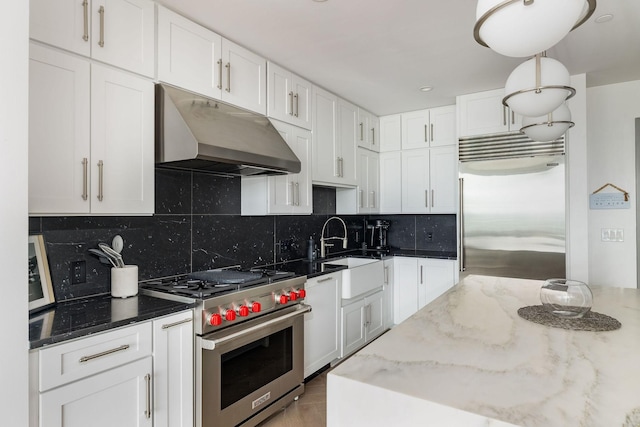 1616 W End Ave Unit 1803, Nashville, TN 37203 - kitchen with high end appliances, white cabinetry, dark stone counters, and under cabinet range hood