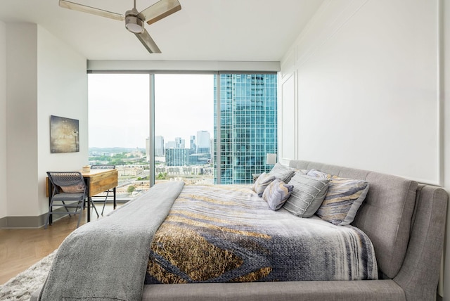 1616 W End Ave Unit 1803, Nashville, TN 37203 - bedroom with a wall of windows, wood finished floors, a ceiling fan, and a view of city