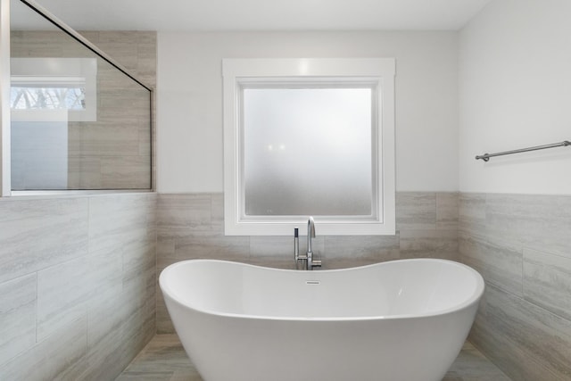 978 Alton Dr, Clarksville, TN 37043 - full bathroom featuring a freestanding bath, tile walls, and a wainscoted wall