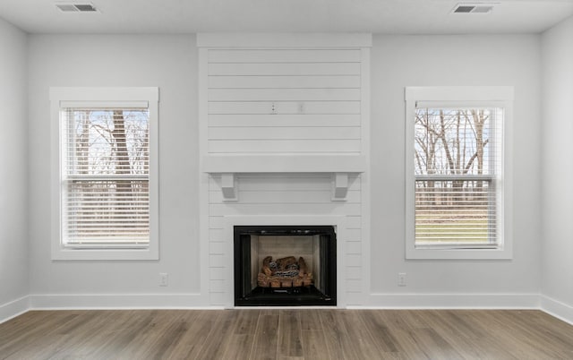 978 Alton Dr, Clarksville, TN 37043 - unfurnished living room featuring baseboards, a large fireplace, wood finished floors, and visible vents