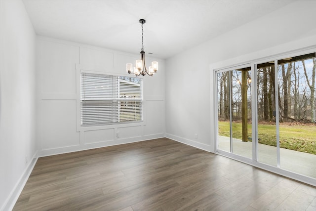 978 Alton Dr, Clarksville, TN 37043 - empty room featuring wood finished floors, baseboards, and a notable chandelier
