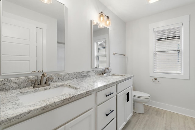 978 Alton Dr, Clarksville, TN 37043 - bathroom with baseboards, a sink, double vanity, and toilet
