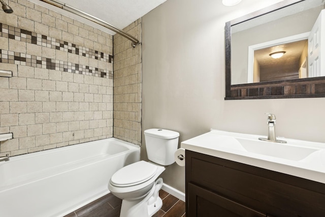 full bath with shower / bathtub combination, baseboards, toilet, wood finished floors, and vanity