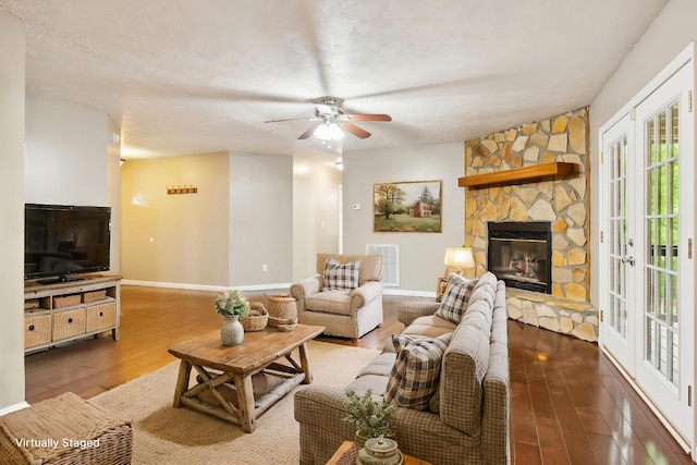 living room with a fireplace, wood finished floors, and baseboards