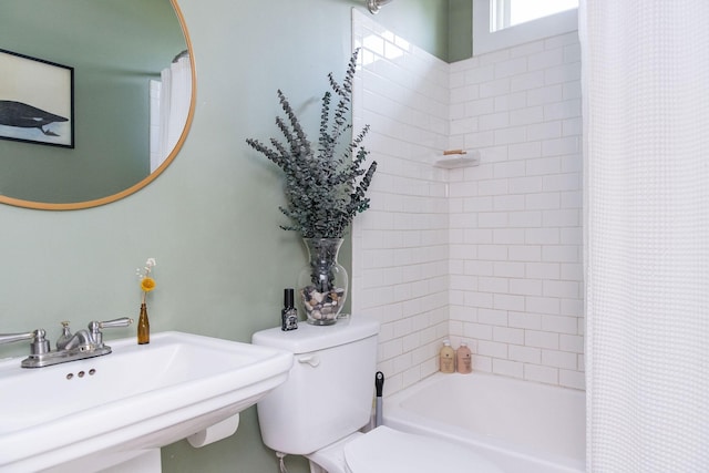 full bathroom with shower / bath combination with curtain, toilet, and a sink