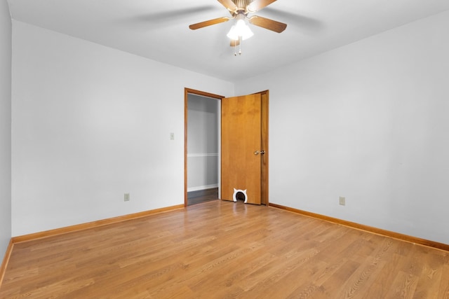unfurnished room featuring baseboards, a ceiling fan, and light wood-style flooring