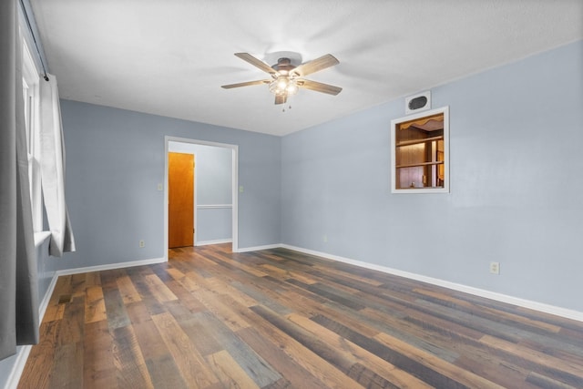 spare room with ceiling fan, baseboards, and wood finished floors