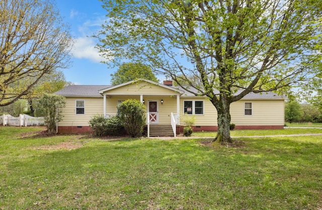 view of front facade featuring a chimney, a front lawn, crawl space, and fence