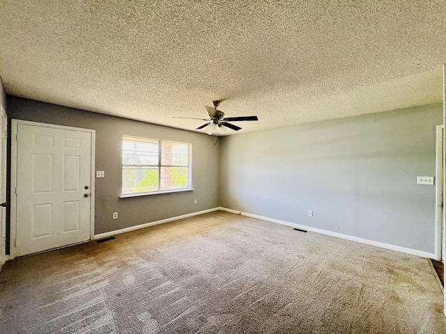 unfurnished room with carpet floors, a textured ceiling, baseboards, and ceiling fan