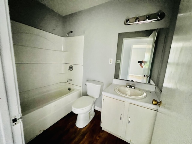 full bath with wood finished floors, vanity, shower / tub combination, and toilet