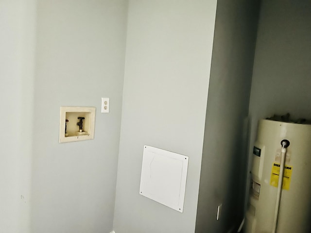 interior space with electric water heater, laundry area, and hookup for a washing machine