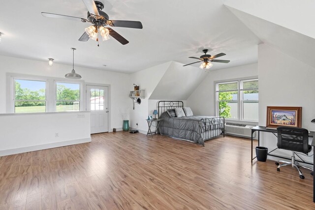 bedroom with baseboards, ceiling fan, and light wood-style flooring
