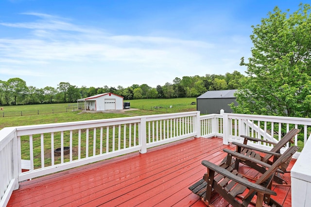 wooden terrace with a lawn, a rural view, an outdoor structure, and a detached garage