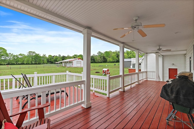 wooden deck featuring a lawn, ceiling fan, and area for grilling