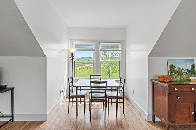 dining room featuring light wood-style floors and baseboards