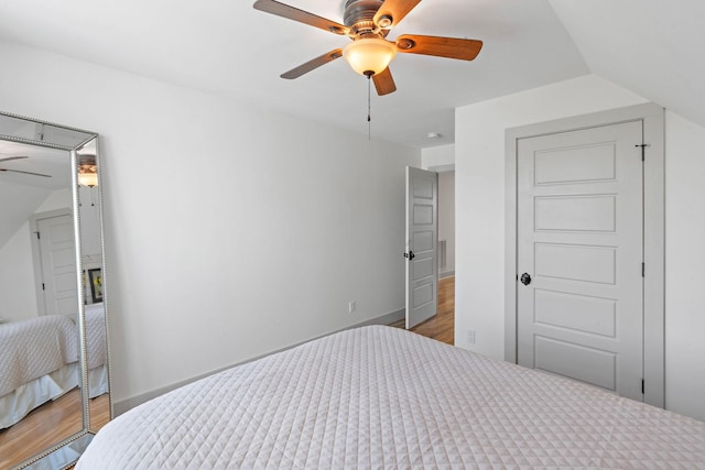 bedroom with baseboards, a ceiling fan, and wood finished floors