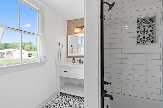 bathroom featuring shower / bath combination, tile patterned floors, baseboards, and vanity