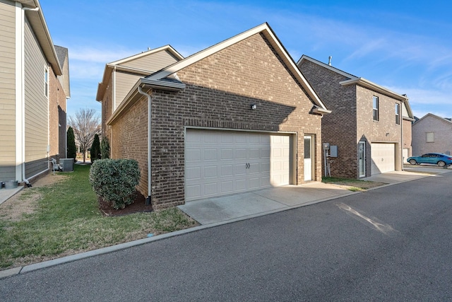 131 Benjamin Ln, Hendersonville, TN 37075 - view of side of home featuring a yard, central AC, driveway, brick siding, and a garage
