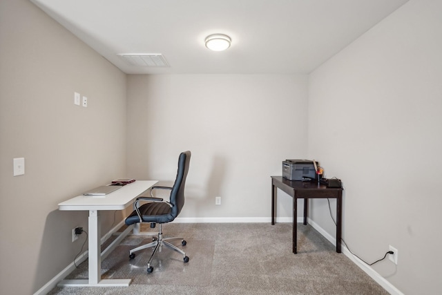 office area featuring visible vents, carpet flooring, and baseboards