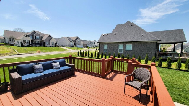wooden deck with a yard, outdoor lounge area, and a residential view