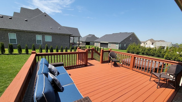 deck with a yard and a residential view