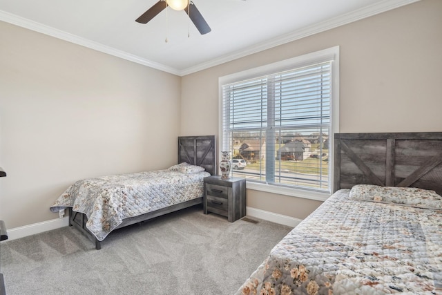 carpeted bedroom featuring a ceiling fan, baseboards, ornamental molding, and multiple windows