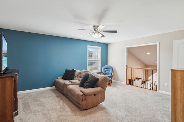 living area with baseboards, carpet floors, an upstairs landing, and ceiling fan