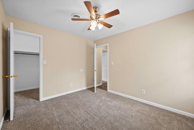 2041 Dotsonville Rd, Clarksville, TN 37042 - unfurnished bedroom with a walk in closet, baseboards, a ceiling fan, and carpet flooring