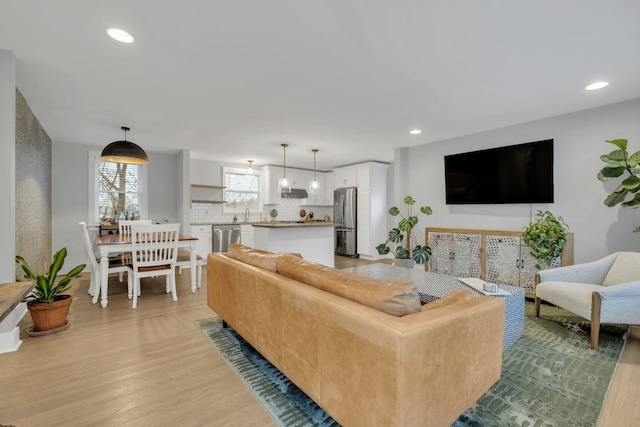 living room featuring light wood-type flooring and recessed lighting