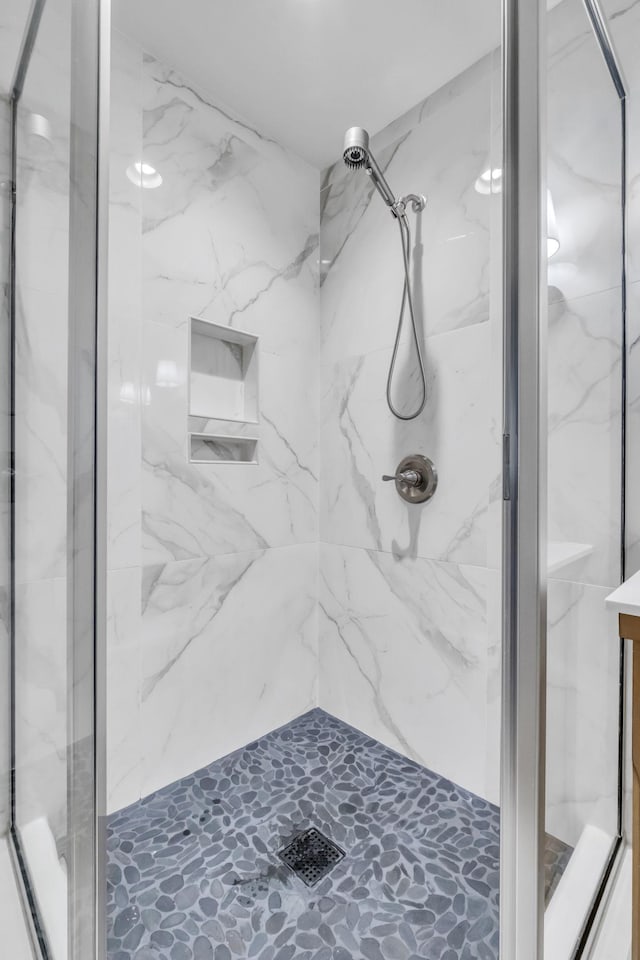 full bathroom with a marble finish shower