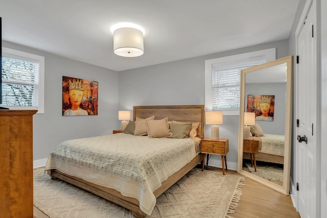 bedroom with baseboards and light wood-style floors