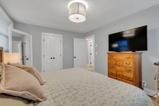 bedroom with baseboards and a closet