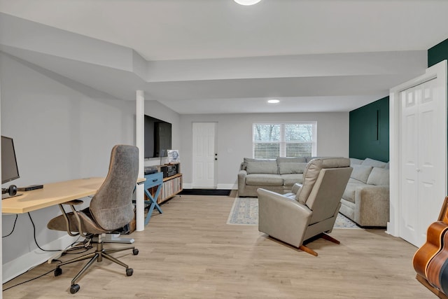 office space featuring light wood-type flooring and baseboards