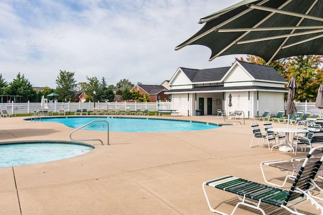 community pool featuring a patio and fence