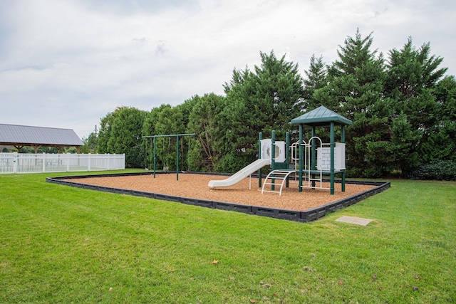 community play area with fence and a yard