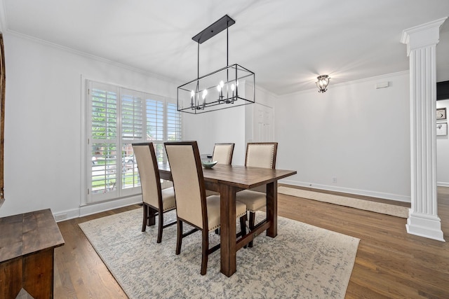 dining area with ornamental molding and decorative columns
