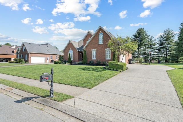 traditional-style house with driveway, a front yard, and brick siding