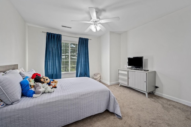 bedroom featuring visible vents, ceiling fan, light carpet, and baseboards