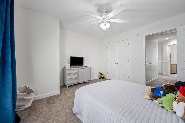 carpeted bedroom with attic access, a closet, ceiling fan, and baseboards