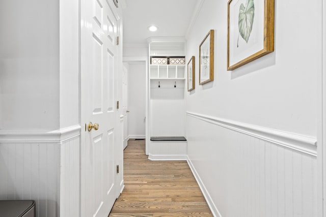 interior space featuring ornamental molding, recessed lighting, wainscoting, and light wood-type flooring