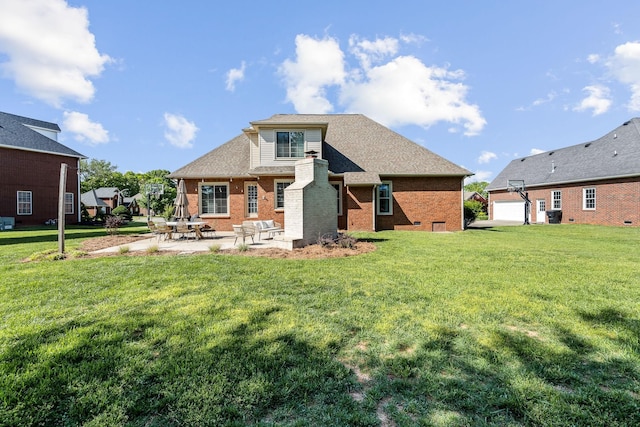 rear view of property with a patio, a lawn, and brick siding