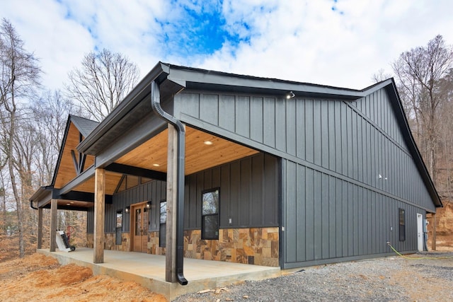 view of home's exterior featuring stone siding and board and batten siding