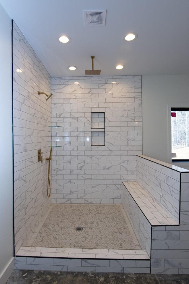 bathroom featuring visible vents, recessed lighting, and a tile shower